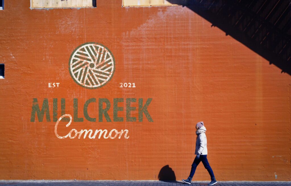 millcreek common logo art on building wall