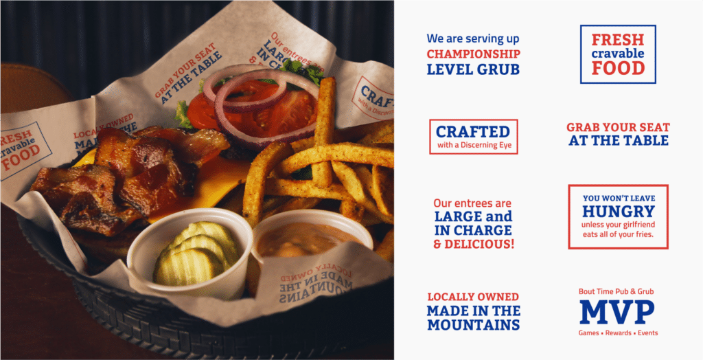 A photograph of a delicious looking bacon cheeseburger and fries, being served in a basket with branded The Bout Time Pub & Grub crinkle paper. Details of the design on the paper; colorful slogans saying things like 'Crafted with a Discerning Eye' and 'Locally Owned, Made in the Mountains'.