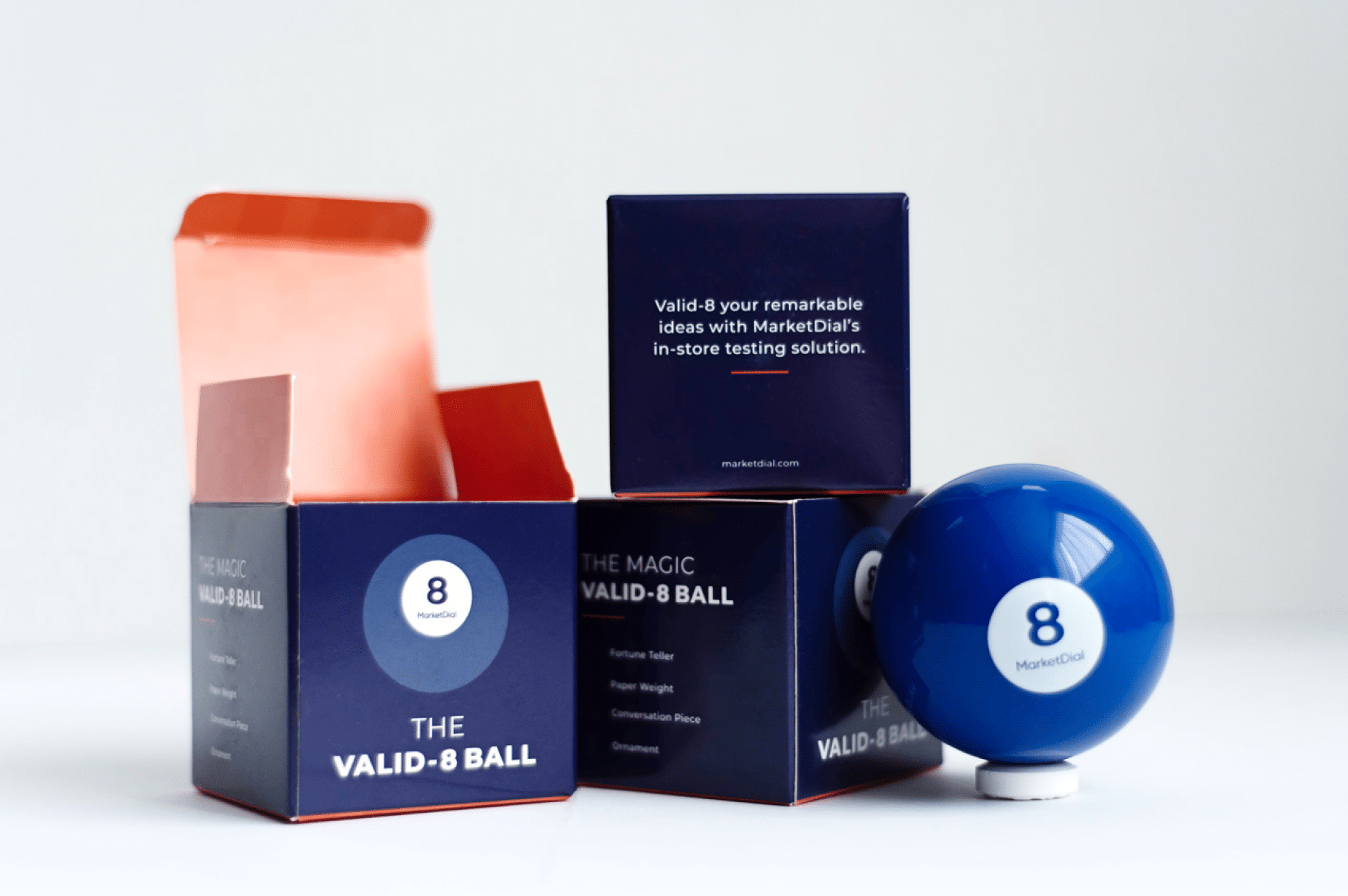 Marketdial branded magic 8 ball, sitting next to a well-designed box meant to hold the magic 8 ball.